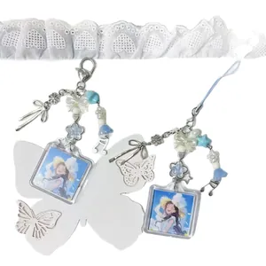 Anime acrylic photo frame keychain with blue beads and musical note charm on lace background