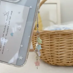 Star-themed pastel beaded phone strap with matte stars and silver charms on light blue case