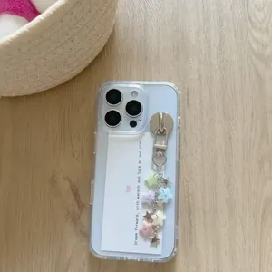 Frosted iPhone case with silver zipper and colorful star charms on a wooden surface