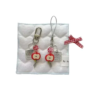 Handmade beaded apple phone charms set with four-leaf clover and heart pendants