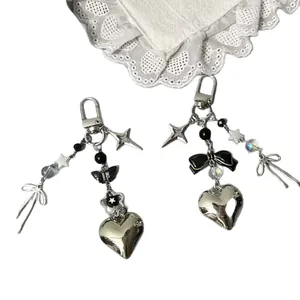 Y2K punk style keychain set with silver heart butterfly and black ribbon pendants