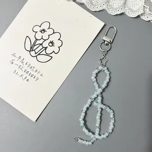 Artistic G-clef beaded phone charm with blue beads and silver star pendant on lobster clasp