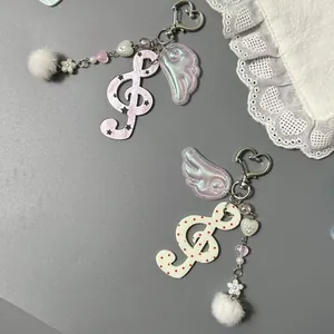 Détails de porte-clés note de musique avec crochet cœur, motif étoile et pompon
