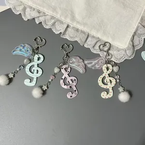 Porte-Clés Clé de Sol Avec Ailes d'Ange Pompon en Fourrure Charme de Coeur pour Sac Décoration Note de Musique Anneau de Clé Bijoux Femme
