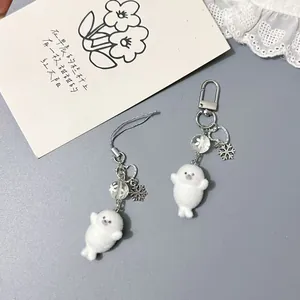 Detail of plush seal charms with snowflake pendant, metal lobster clasp and phone strap