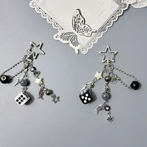Y2K style keychain with billiard 8 ball, dice, and star charms on metal stars clasp