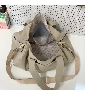 Interior view of beige travel tote showing spacious main pocket and logo lining