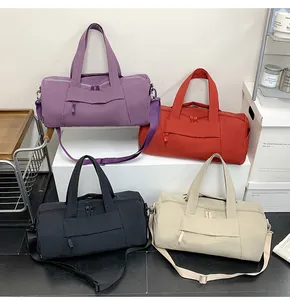 Detailed display of large travel tote bags in purple, orange, black and beige colors