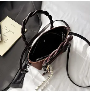 Macro shot showing internal zipper pocket and spacious interior of the brown tote bag