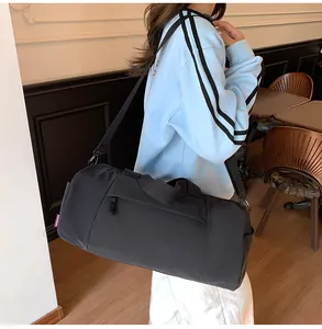 Detail of black waterproof nylon yoga bag with adjustable strap and side zipper compartment
