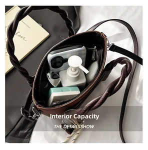 Spacious interior of brown leather handbag with zipper pocket and daily essentials