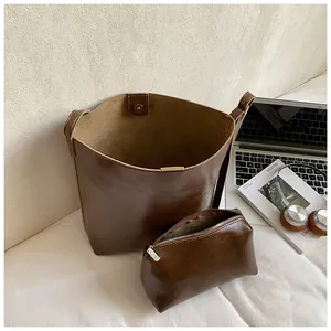Brown vintage textured bucket bag set with matching zipper pouch and magnetic closure