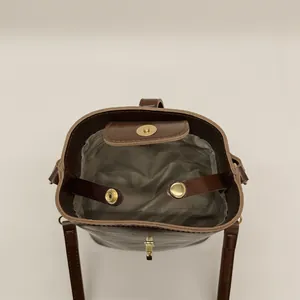 Vintage dark brown bucket bag featuring gold metal hardware and a spacious interior