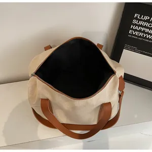 Top view of spacious interior storage in a canvas tote bag with brown leather straps