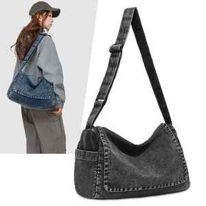 Unisex denim messenger bag in blue and black with adjustable wide shoulder strap