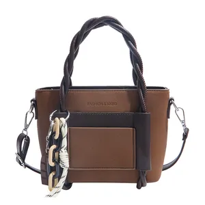 Brown patchwork faux leather handbag with braided rope handles and a detachable shoulder strap