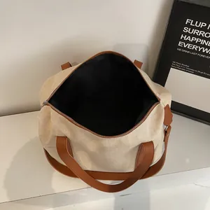 Large capacity canvas shoulder bag in beige with brown leather handles and zipper closure