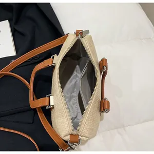 Detailed interior of woven straw handbag showing fabric lining and zipper pocket