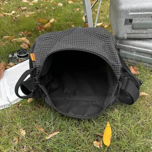 2025 casual black grid tote bag with orange label on outdoor grass with camera