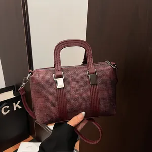 Elegant wine red Boston handbag with woven texture and adjustable shoulder strap for women