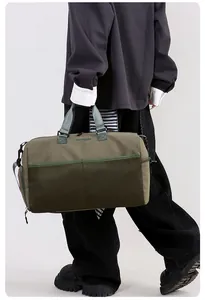 Close-up of olive green travel bag with mesh pocket and sunlight embroidery detail