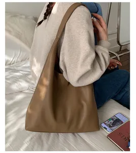 Detailed close-up of brown pebble grain faux leather material on a large tote bag