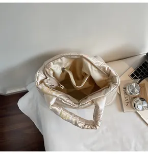 Detail view of the internal multi-pocket structure and zipper compartment of the tote bag