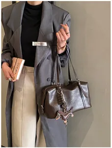 Brown vintage oil wax leather tote bag with cute dog pendant and chocolate charm