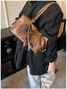 Detail of vintage brown leather bag with chocolate and dachshund pendants in a lifestyle setting