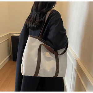 Detail of minimalist canvas tote bag with brown straps and large capacity for women