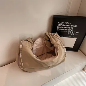 Minimalist beige nylon tote bag with large capacity and woven drawstring handles
