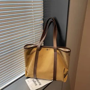 Retro yellow canvas tote bag with brown handles and large capacity in soft natural light