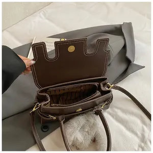 Dark brown faux leather handbag with contrast stitching and interior compartment