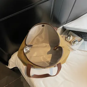 Large khaki canvas tote bag with brown straps and magnetic closure for daily commute