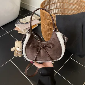 Brown suede crescent handbag with white faux fur trim and cute bear charm pendant