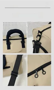 Detail view of reinforced handles, metal hooks, and smooth zippers on the beige oxford bag