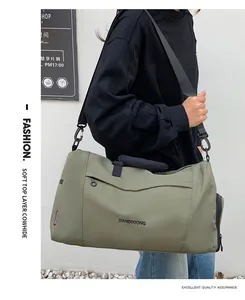 Deep green oxford fabric travel bag detail with adjustable strap and side zipper pocket