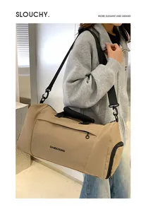 Khaki oxford cloth travel bag with adjustable strap and side shoe compartment on model