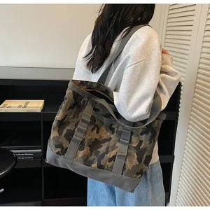 Macro detail of the durable camouflage canvas tote bag with thick grey straps