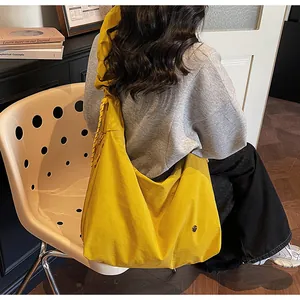 Detail of the bright yellow pleated tote bag with a wide strap for daily commute