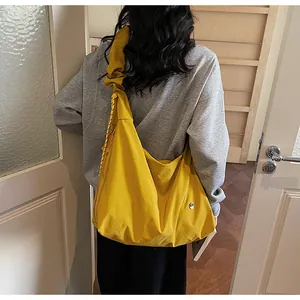 Detail of the bright yellow hobo bag showing the wide strap and durable canvas texture