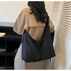 Detailed shot of large black pleated hobo bag in nylon material for daily commuting