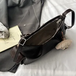 Retro dark brown oily leather pillow bag with silver zipper and plush bear charm