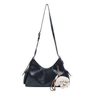 Retro black leather hobo bag with large capacity and cute white puppy plush charm