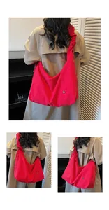 Detail of the pleated strap and soft nylon texture on this large red crescent tote bag