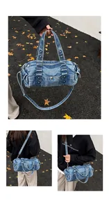 Dettaglio borsa in denim lavato con rivetti metallici e ampio manico dal design vintage