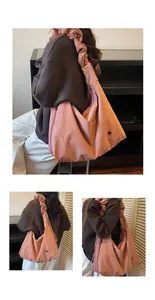 Detail of pink pleated tote bag with side drawstring and metallic logo badge