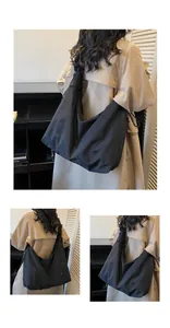 Close-up of minimalist black oversized tote bag with nylon texture and side drawstring