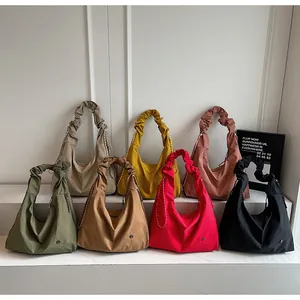 Close-up showing the ruched handles and color variety of large casual tote bags