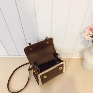 Vintage retro patchwork contrast shoulder bag in dark brown and beige with a top flap